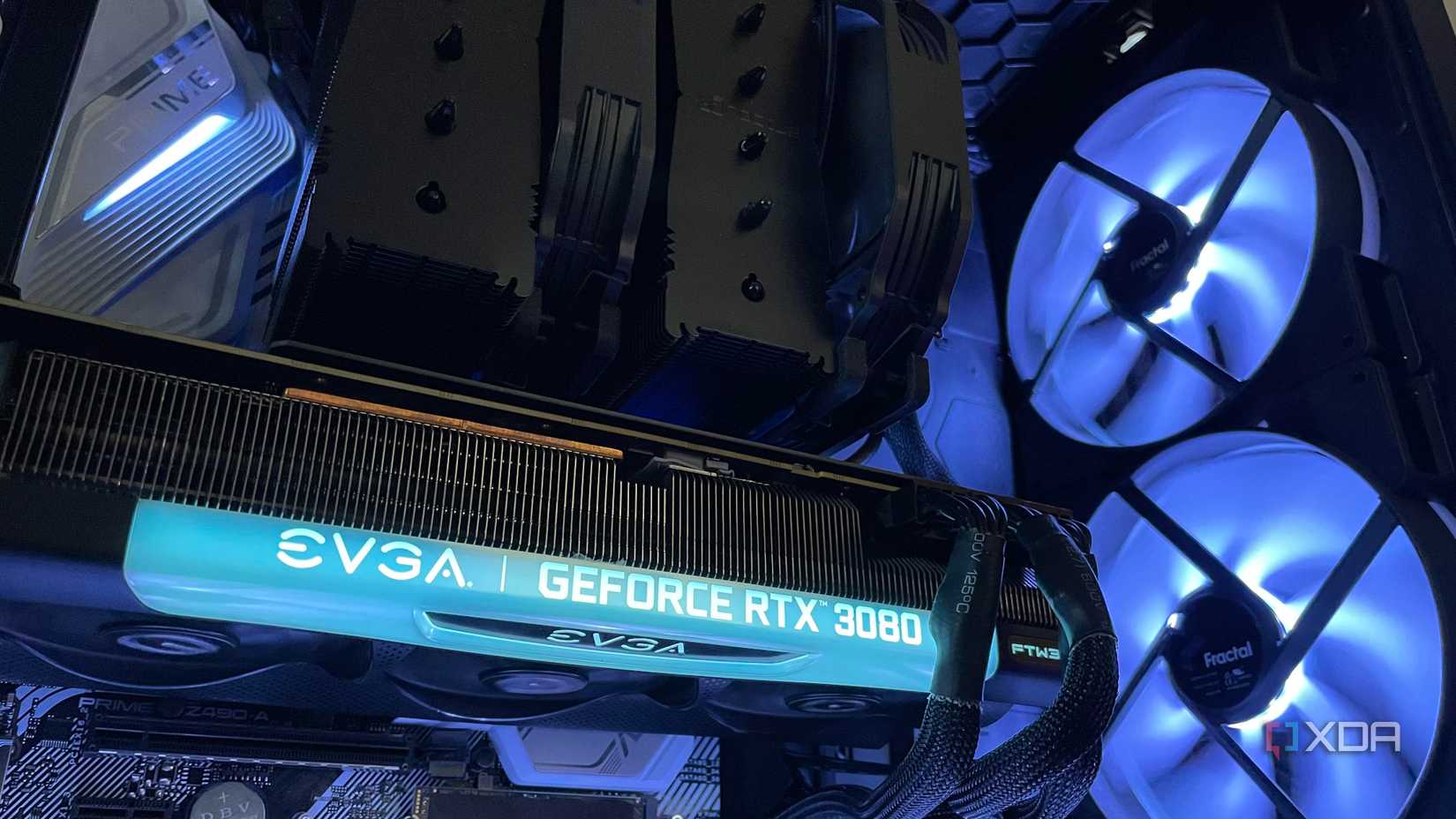 The inside of a PC build, with a black air cooler, EVGA 3080 and large intake RGB intake fans.