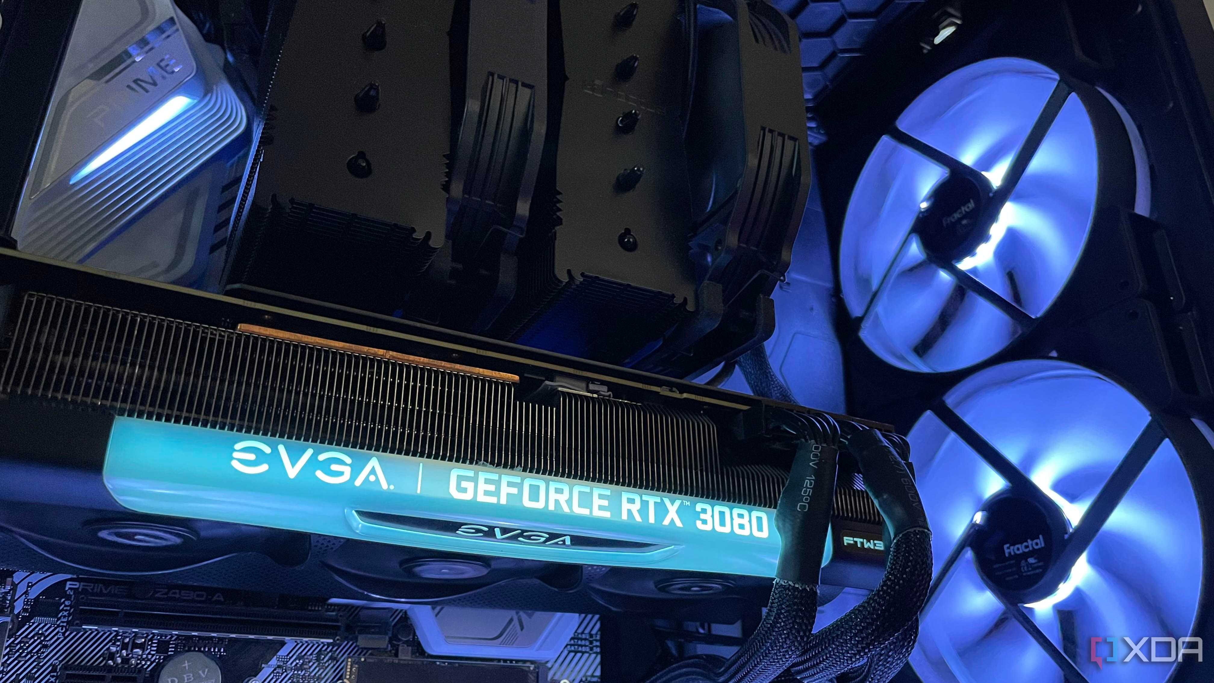 The inside of a PC build, with a black air cooler, EVGA 3080 and large intake RGB intake fans.