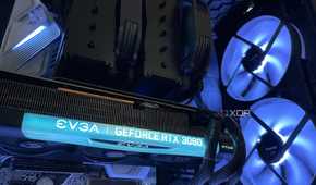 The inside of a PC build, with a black air cooler, EVGA 3080 and large intake RGB intake fans.