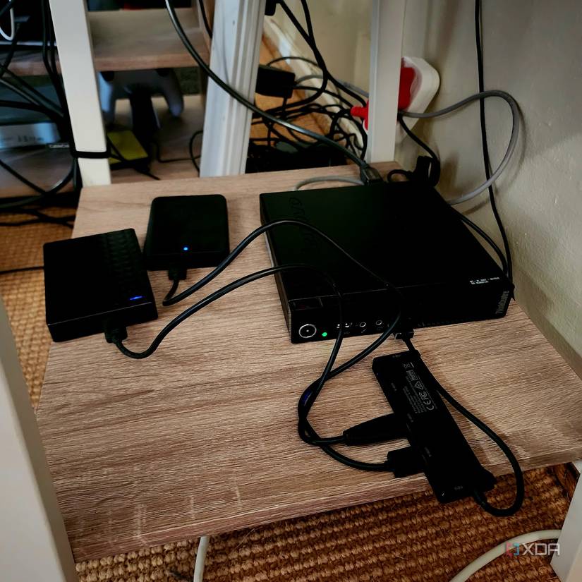 A mini PC with two USB hard drives connected.