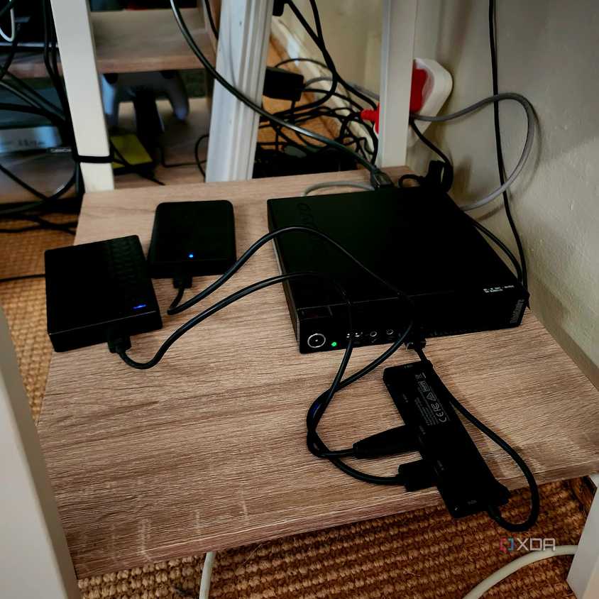A mini PC with two USB hard drives connected.