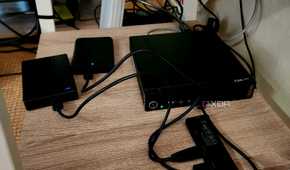 A mini PC with two USB hard drives connected.