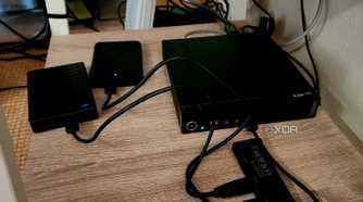 A mini PC with two USB hard drives connected.