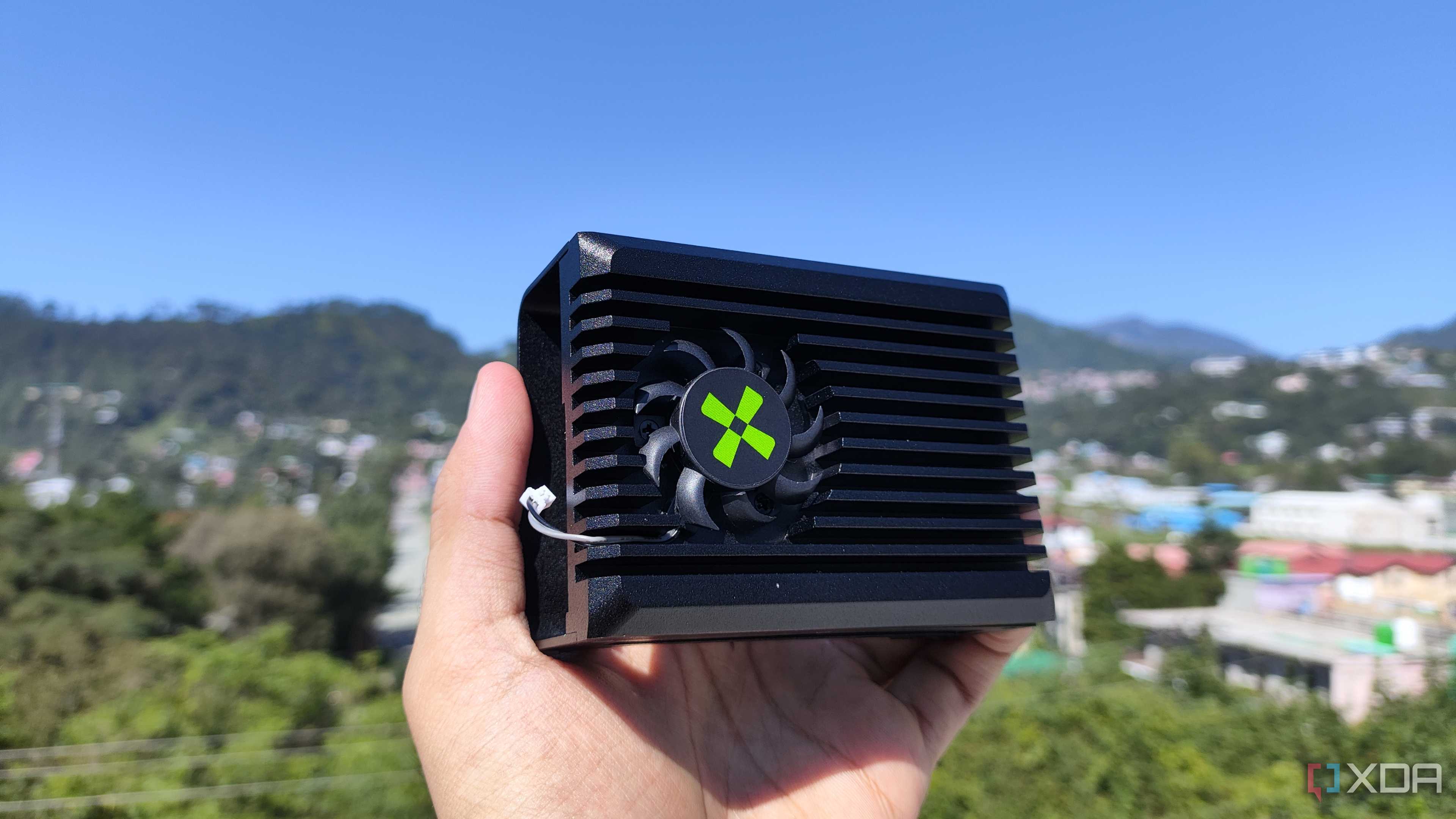 A person holding the heatsink of a Radxa X4 SBC