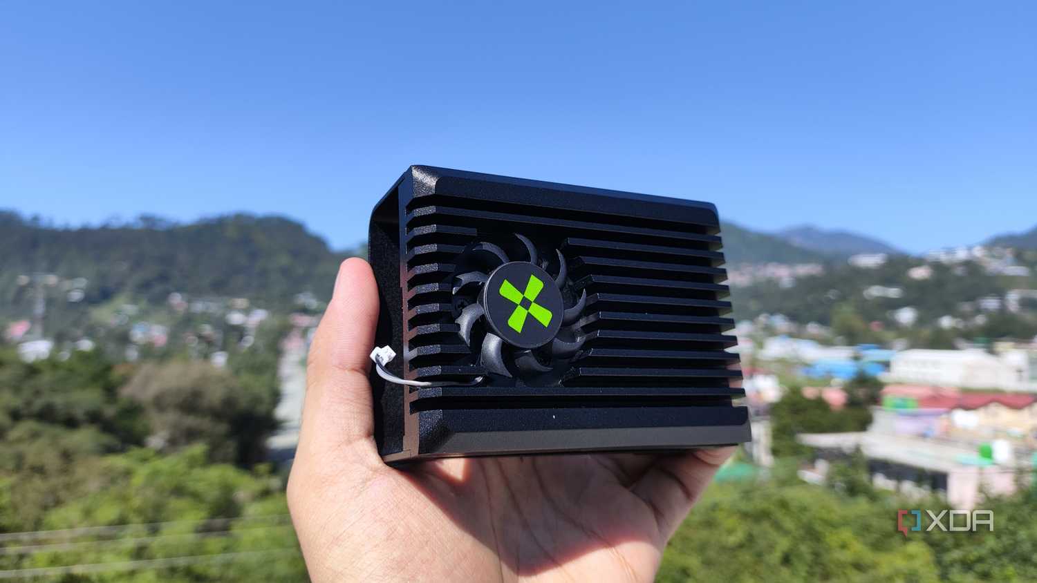 A person holding the heatsink of a Radxa X4 SBC