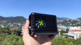 A person holding the heatsink of a Radxa X4 SBC
