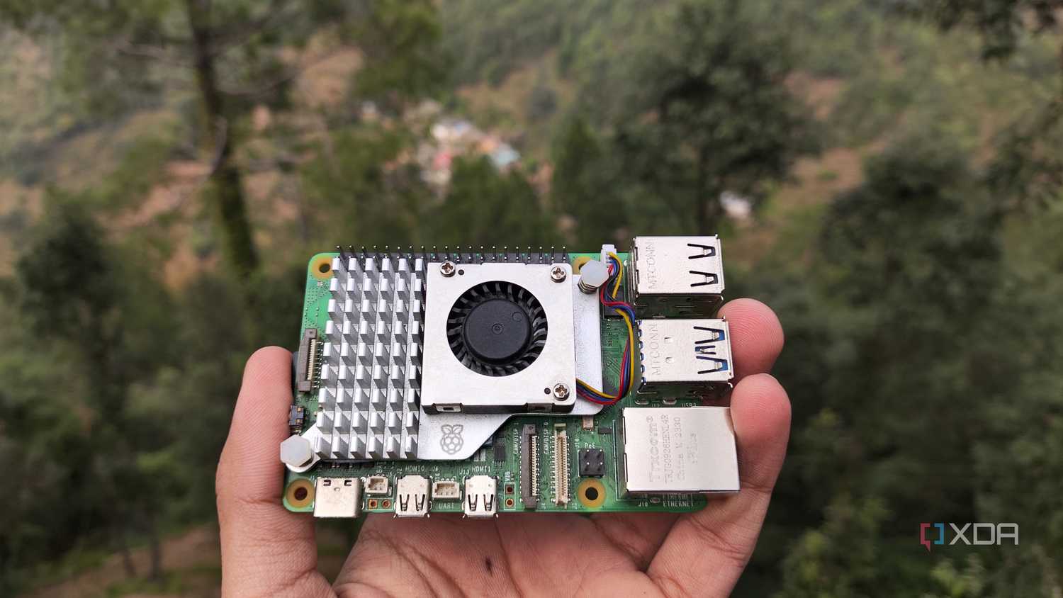 A person holding a Raspberry Pi 5