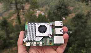 A person holding a Raspberry Pi 5