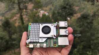 A person holding a Raspberry Pi 5
