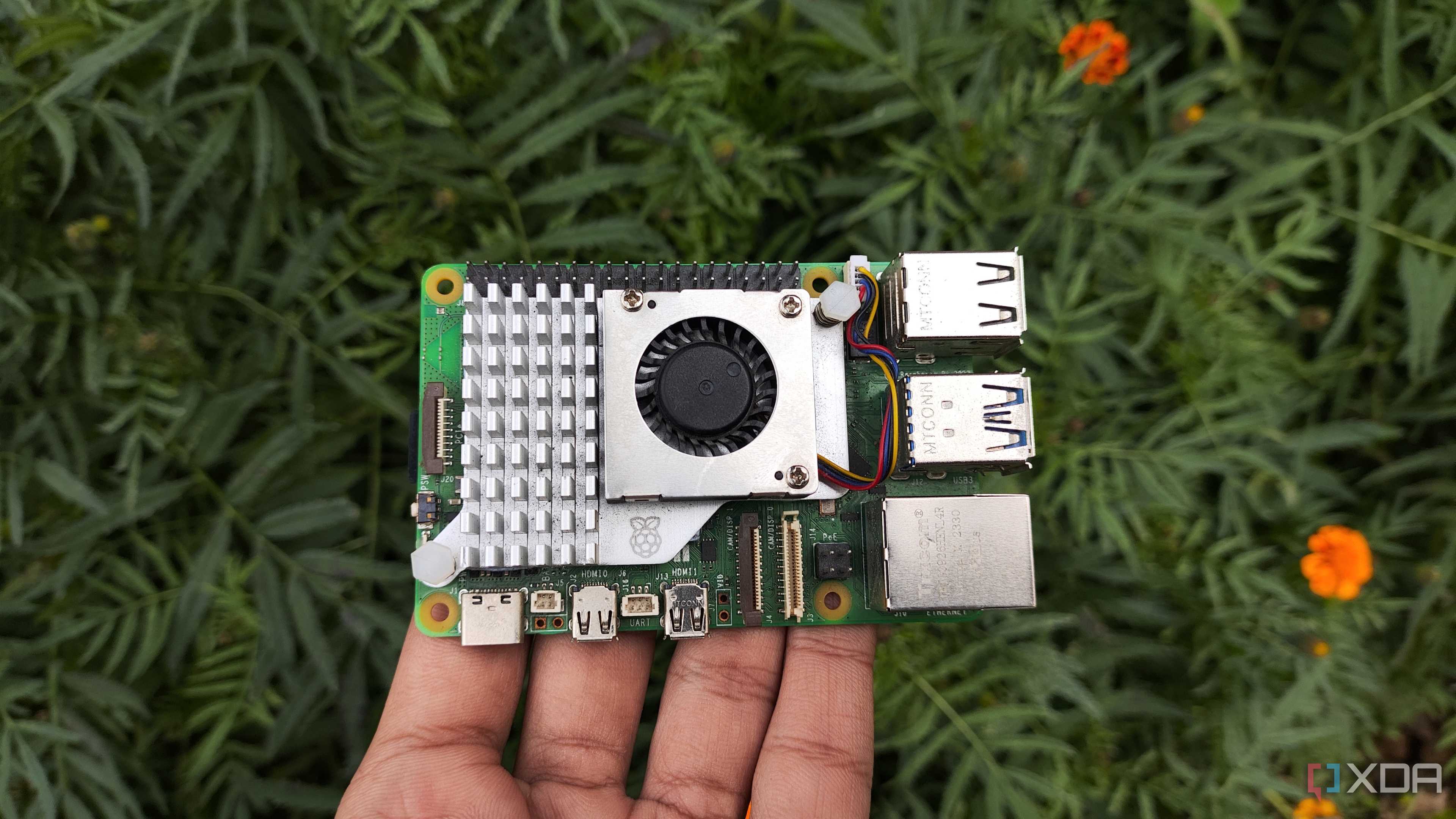 A person holding a Raspberry Pi 5