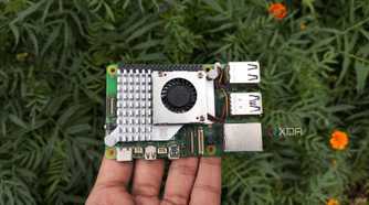 A person holding a Raspberry Pi 5