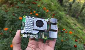 A person holding a Raspberry Pi 5