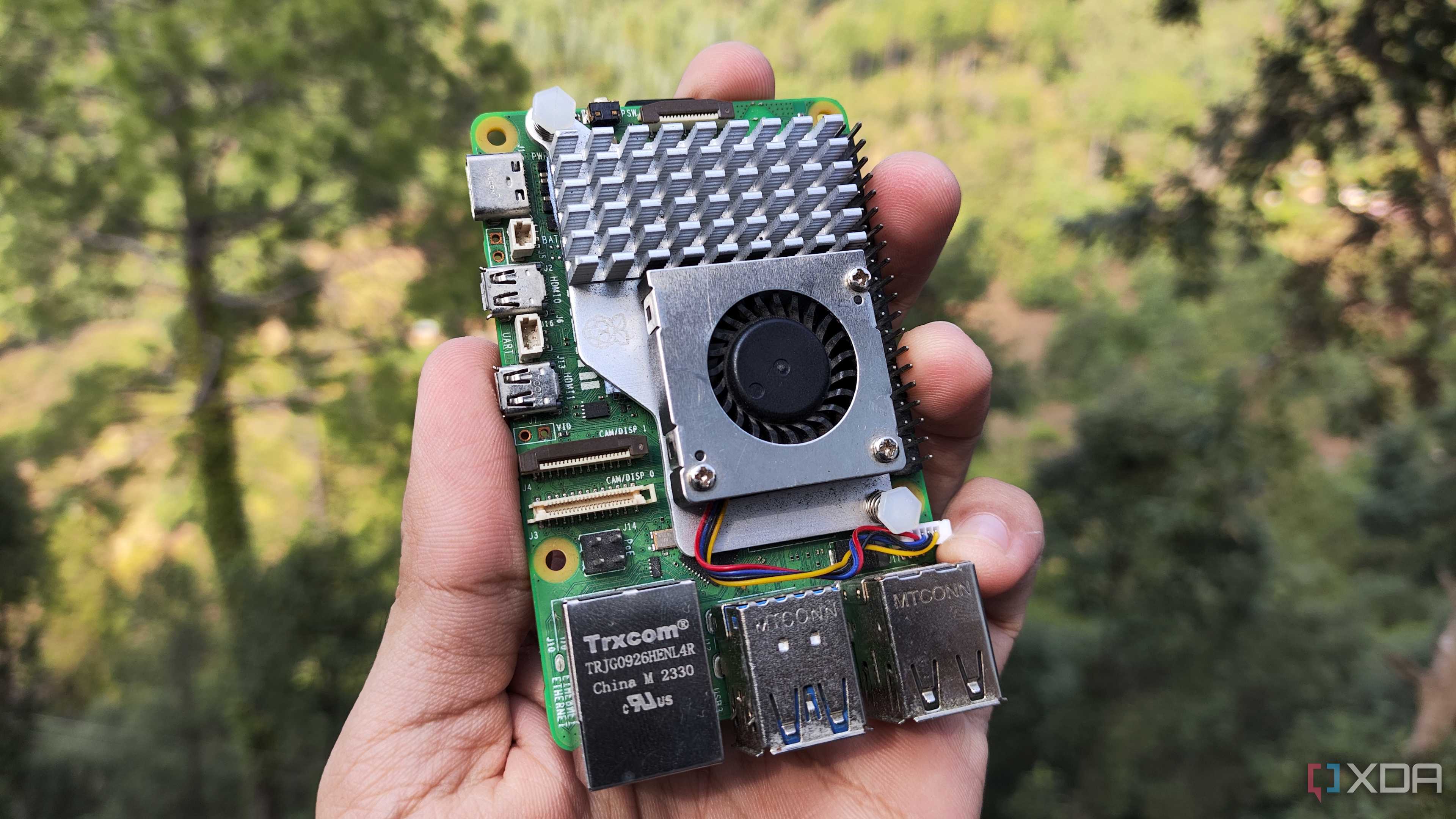 A person holding a Raspberry Pi 5
