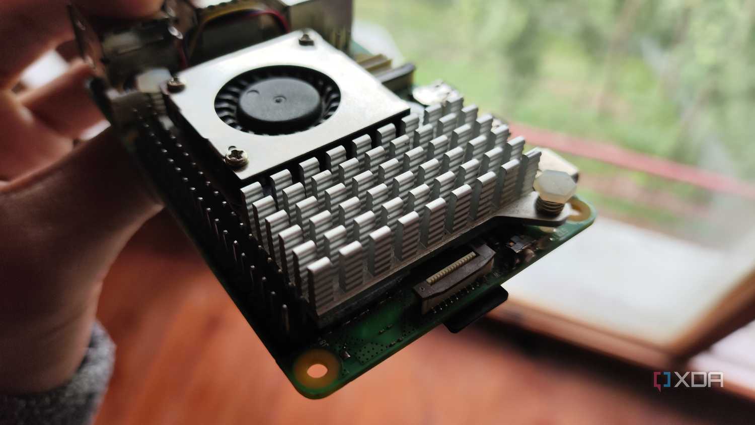 A person holding a Raspberry Pi 5
