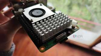A person holding a Raspberry Pi 5