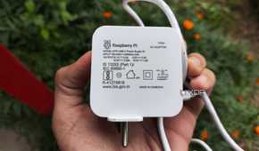 A person holding a Raspberry Pi power supply