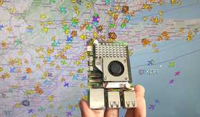 A person holding a Raspberry Pi 5 in front of an airplane tracking system