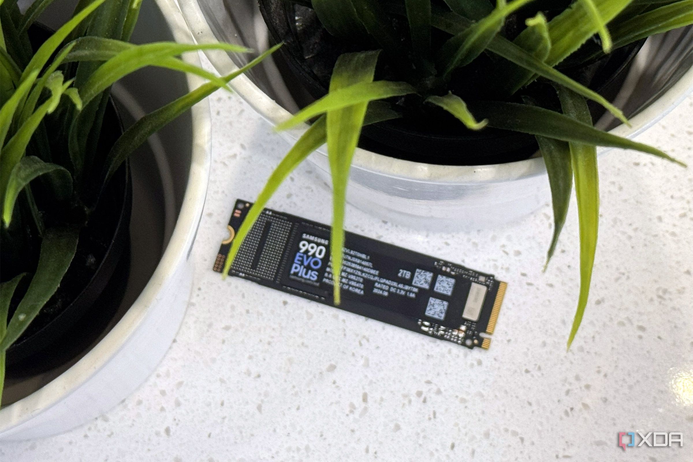 An image of a Samsung 990 evo plus ssd on countertop.