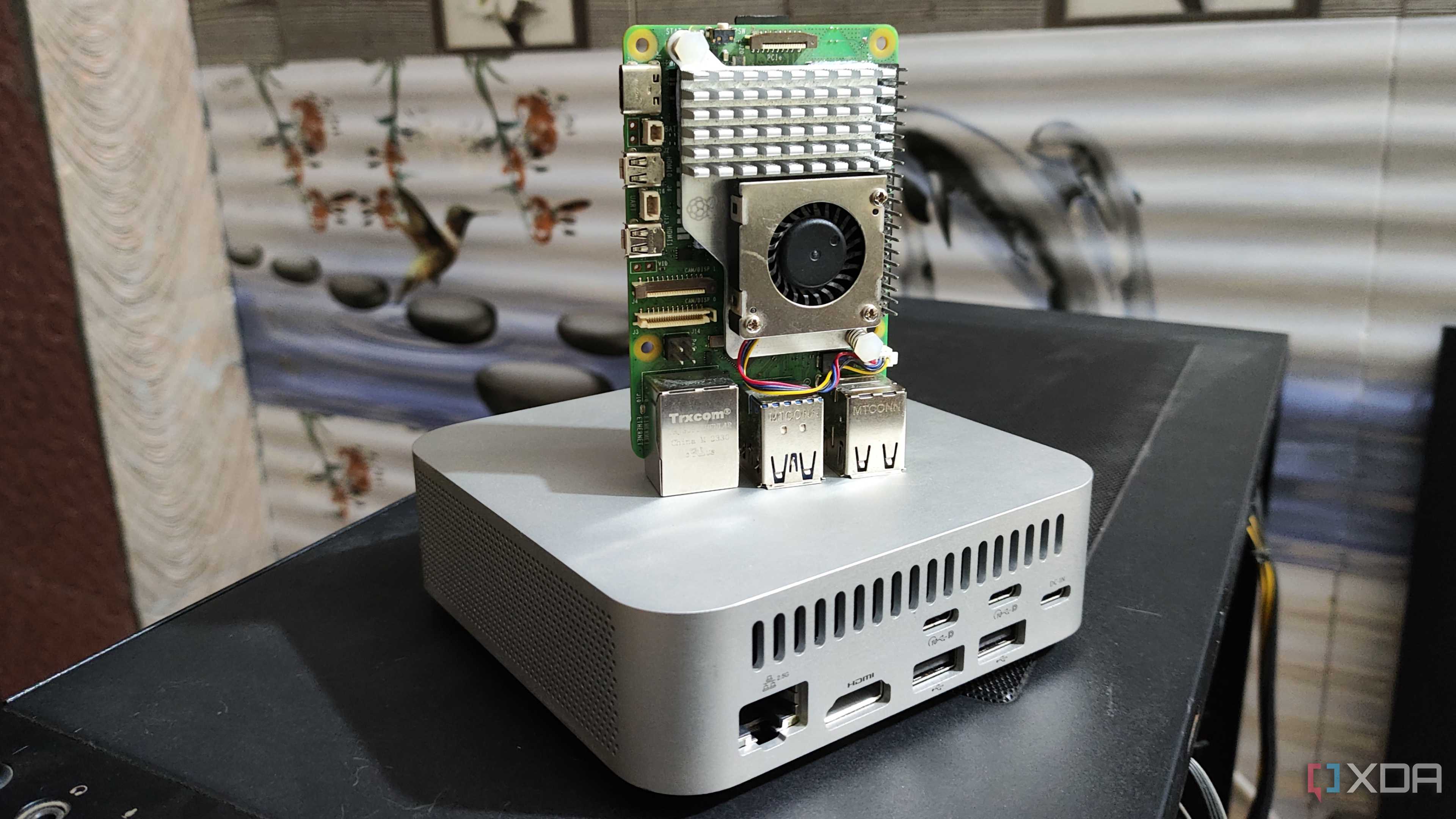 A Raspberry Pi 5 placed on top of an Aiffro K100 NAS