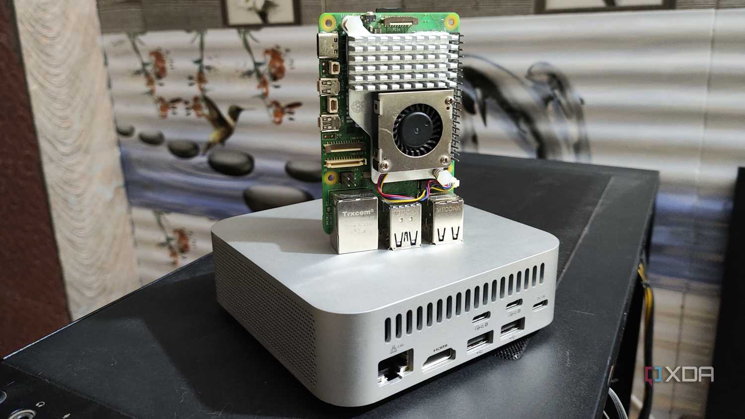A Raspberry Pi 5 placed on top of an Aiffro K100 NAS