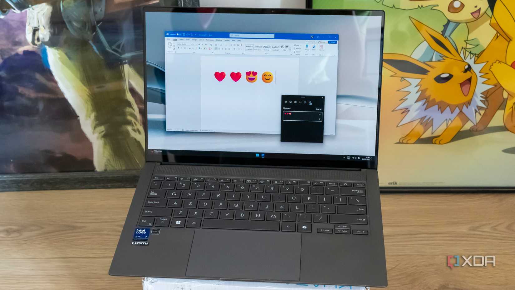 A laptop running microsoft Word with various emoji inserted and the clipboard panel open showing some copied content