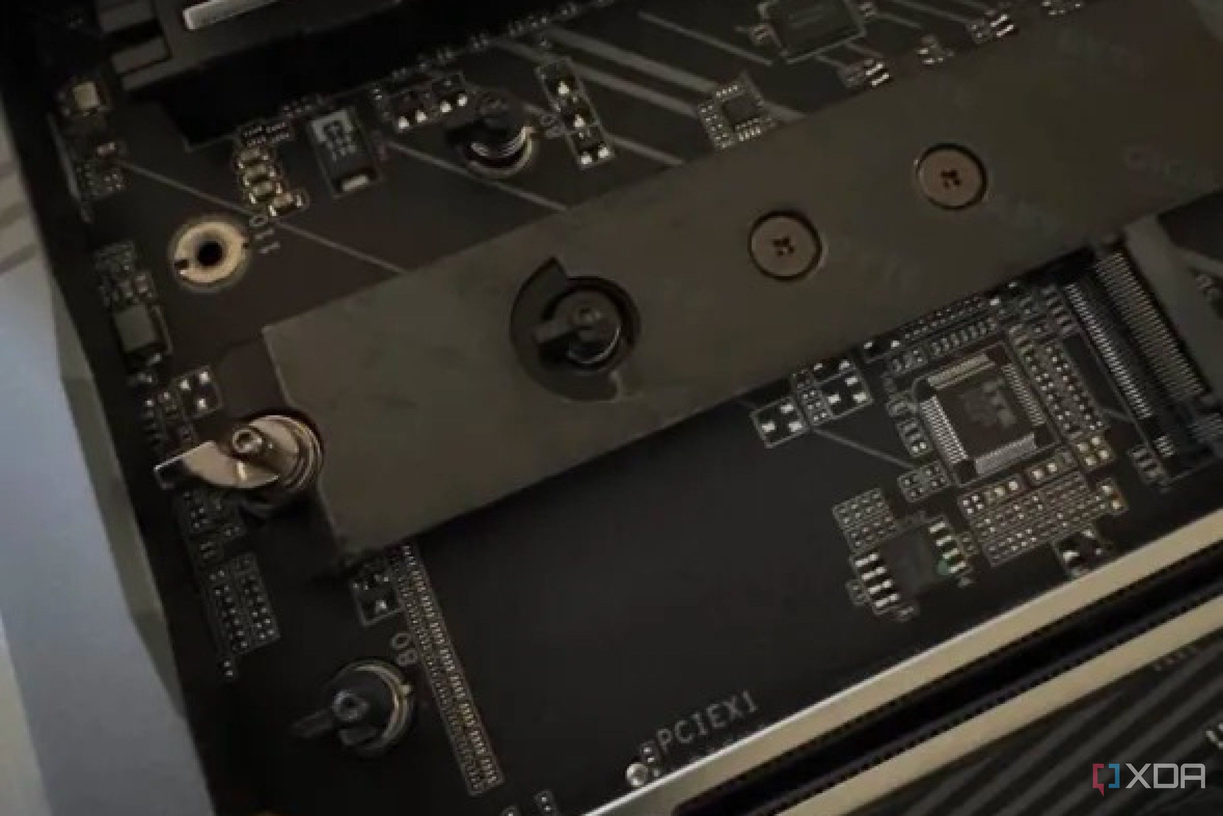closeup of the m.2 slots on the z890 aorus master motherboard showing their quick-release clamps