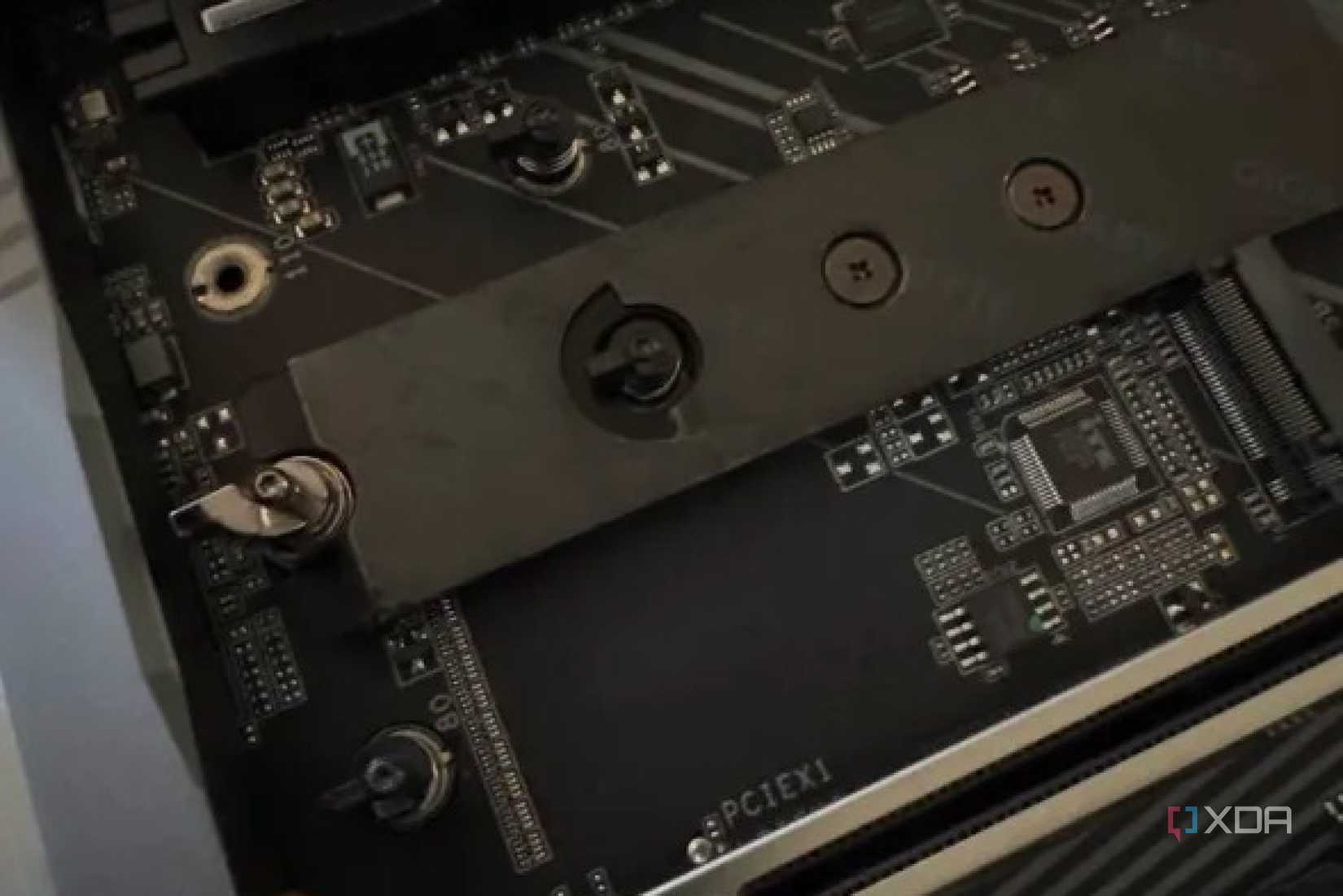 closeup of the m.2 slots on the z890 aorus master motherboard showing their quick-release clamps