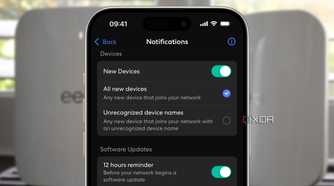 eero app showing new device notification setting over a blurred background of two white routers