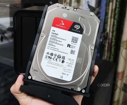 A person holding a Seagate HDD