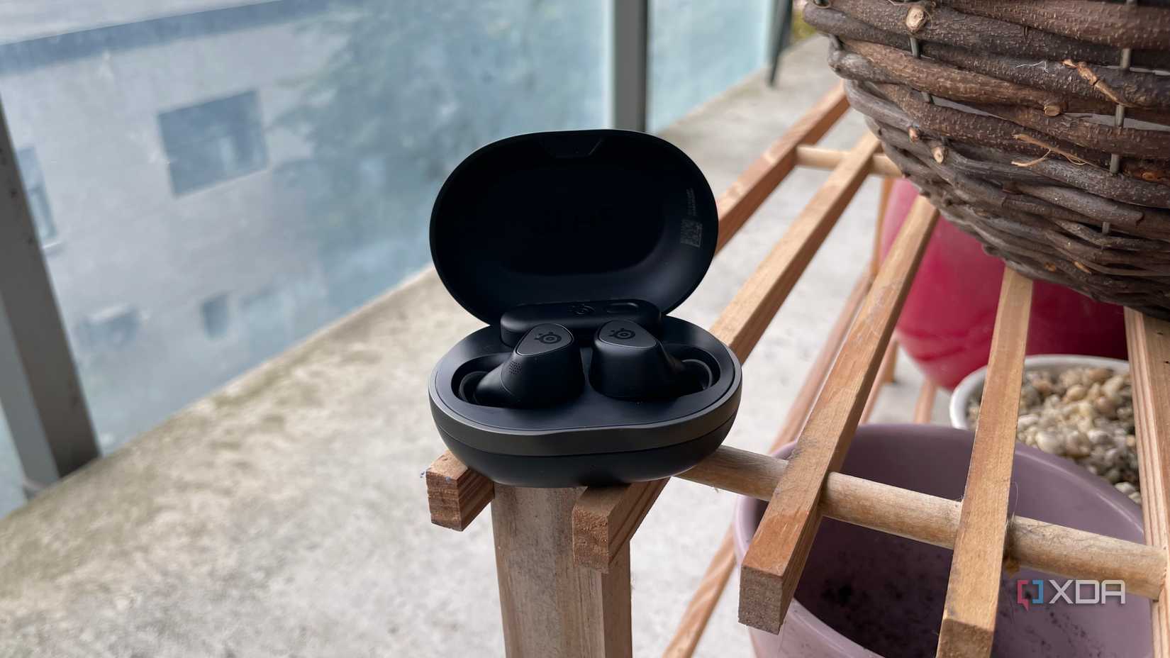 SteelSeries Arctis GameBuds displayed in their charging case