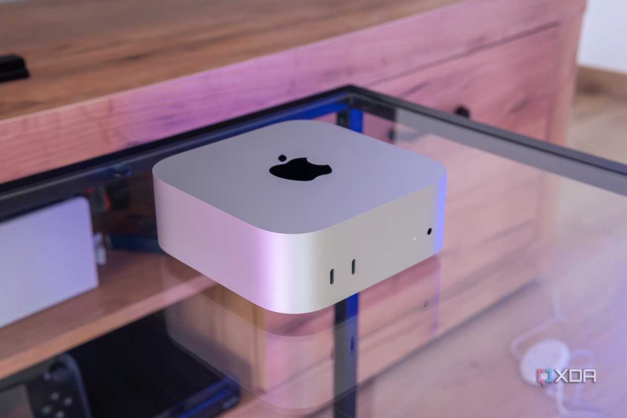Angled view of the M4 Mac Mini on a glass table