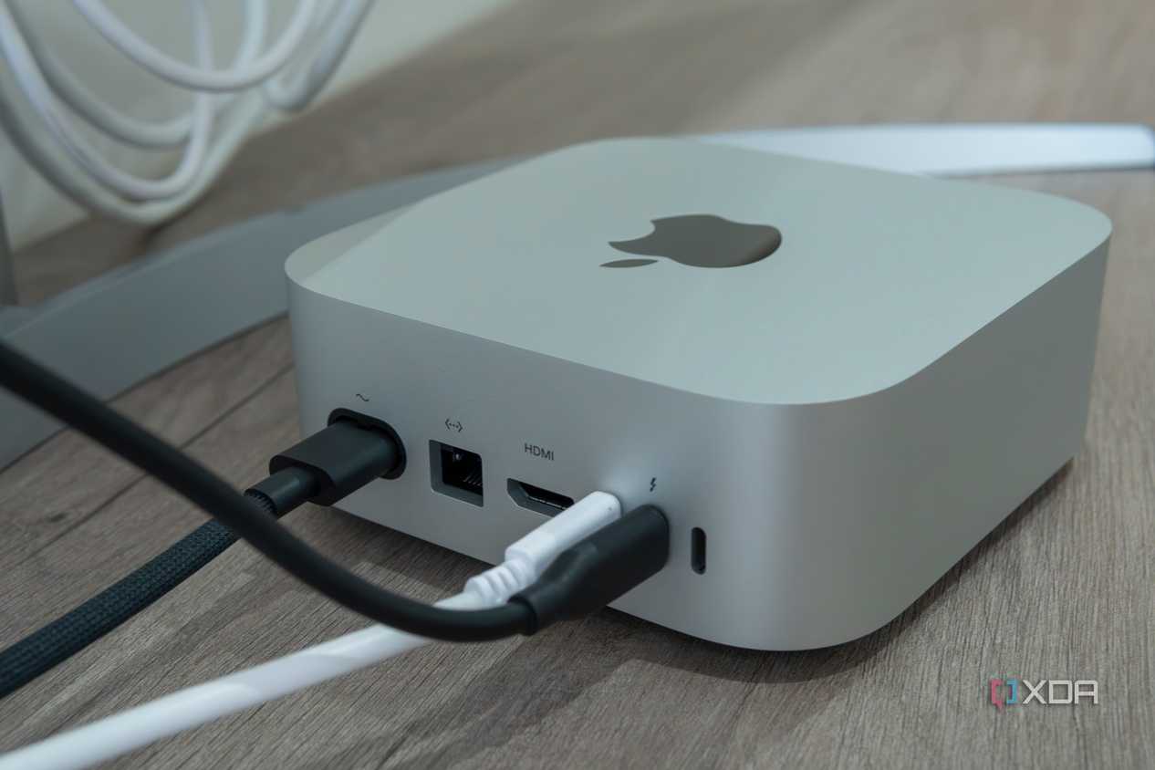 Angled rear view of the M4 Mac Mini with cables plugged into some of the ports