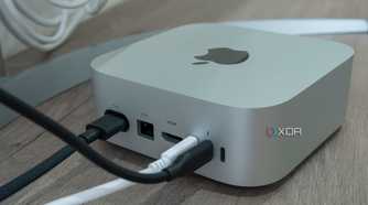 Angled rear view of the M4 Mac Mini with cables plugged into some of the ports
