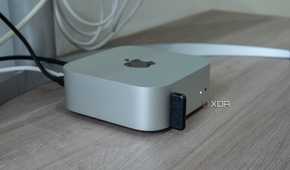 Side view of the M4 Mac Mini with a USB dongle plugged into one of the ports on the front
