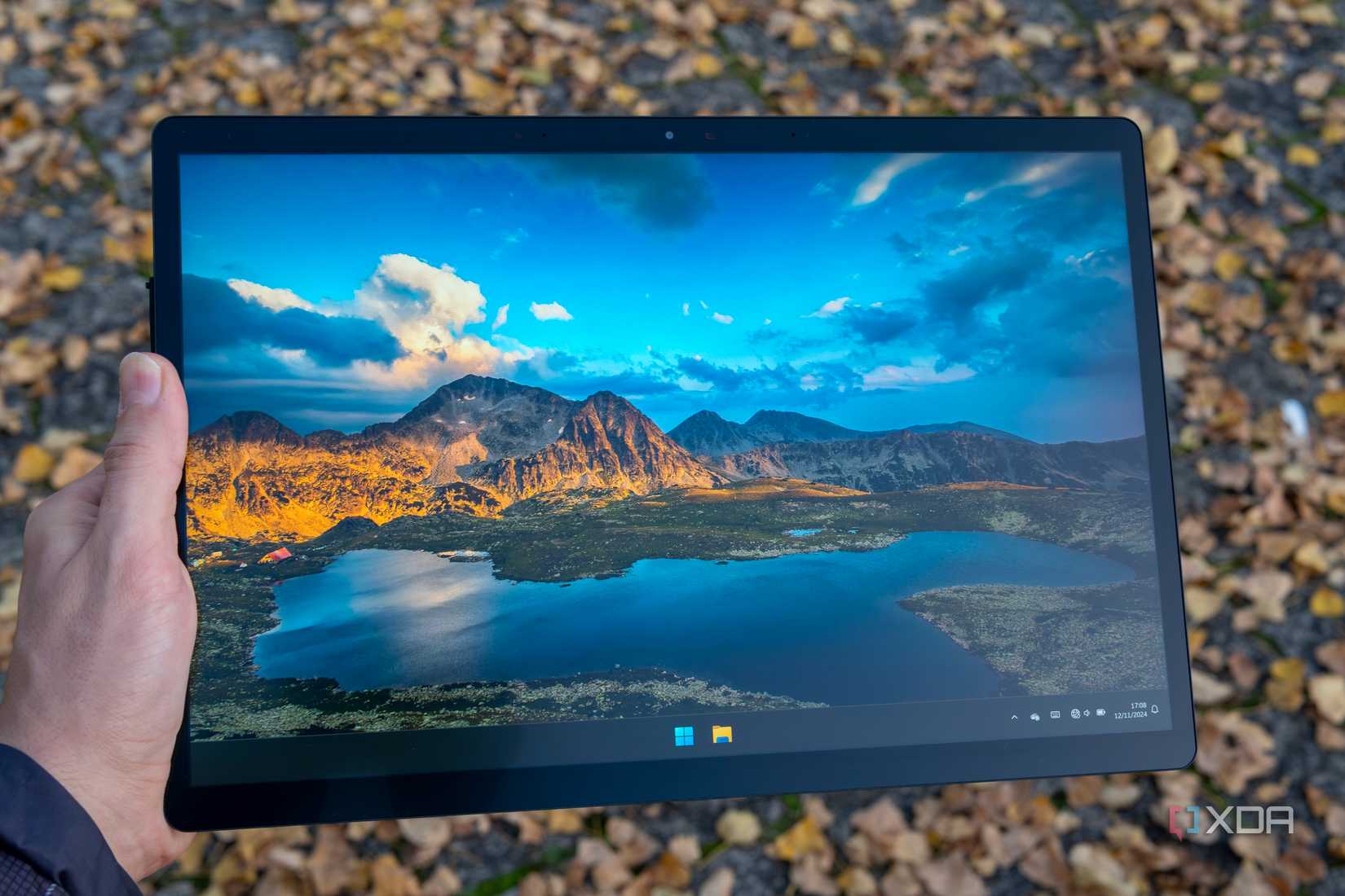 A Minisforum V3 tablet held in someone's hand