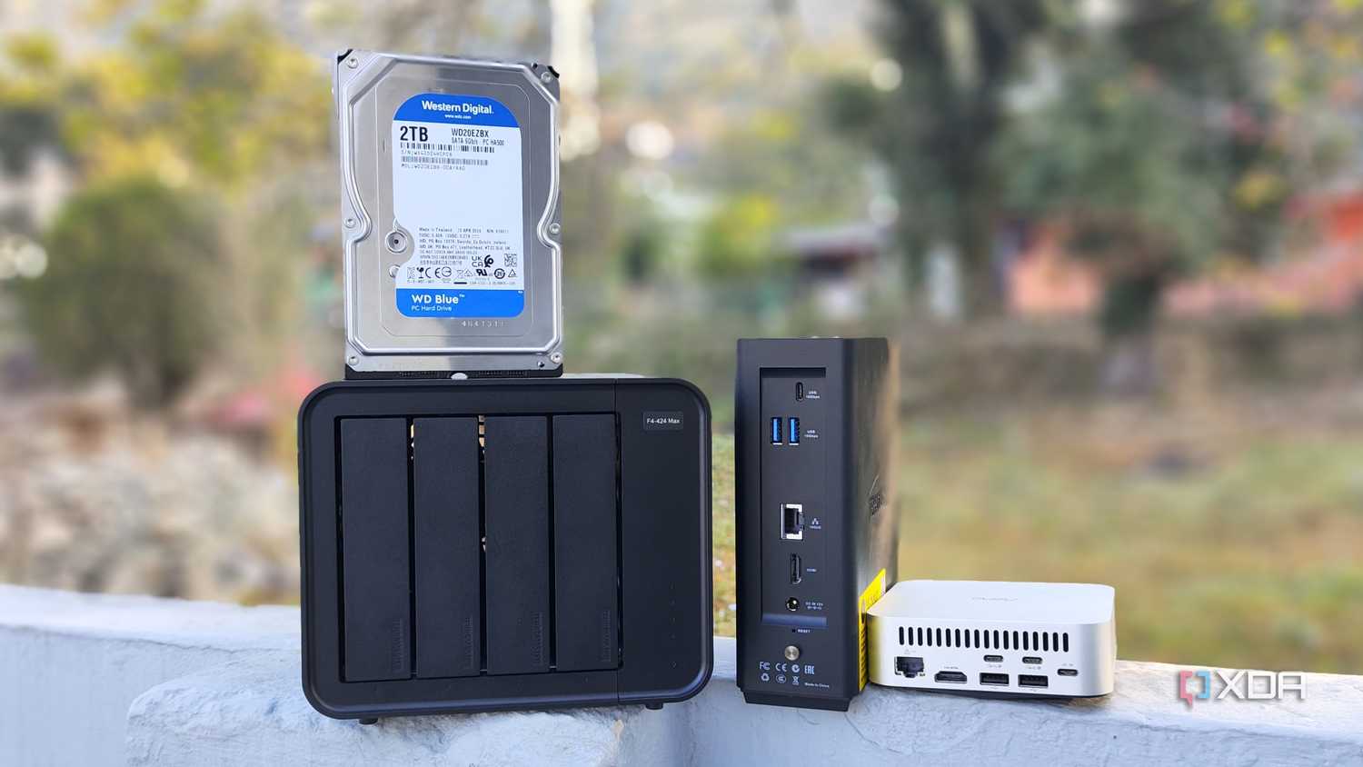 A TerraMaster F4-424 Max, F8 SSD Plus, and an Aiffro K100 placed side-by-side