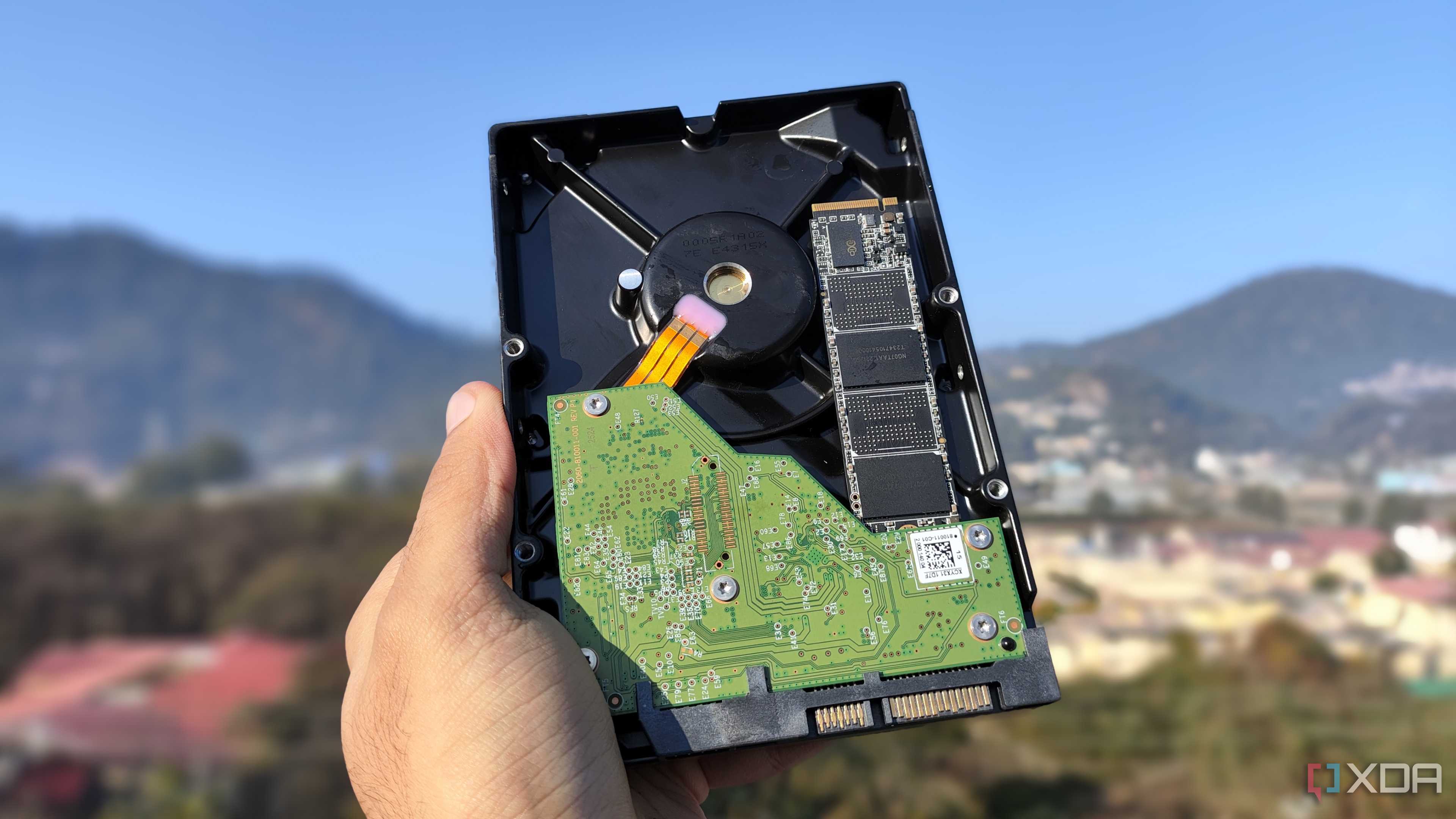 A person holding an HDD and an SSD
