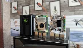 A Raspberry Pi 5, a Radxa X4, and a Libre Computer Alta SBC resting on top of a PC
