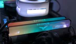 An image of RGB RAM modules installed on a motherboard across a CPU fan.