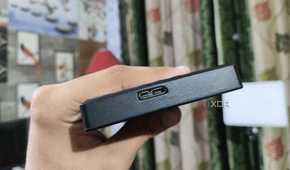 A person holding an external HDD