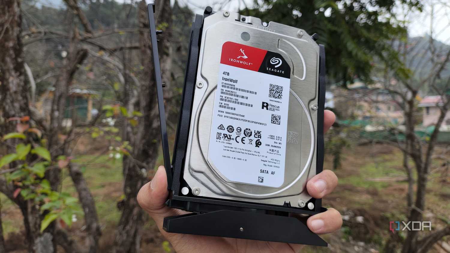A person holding a 4TB Seagate HDD