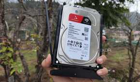 A person holding a 4TB Seagate HDD