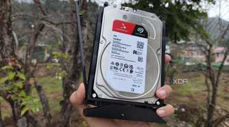 A person holding a 4TB Seagate HDD