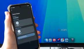 An Android phone trying to share a file using Quick Share with a Mac desktop in the background. The phone shows a Mac Mini as an available sharing target