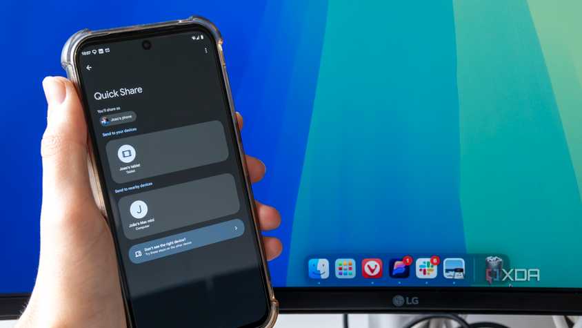 An Android phone trying to share a file using Quick Share with a Mac desktop in the background. The phone shows a Mac Mini as an available sharing target
