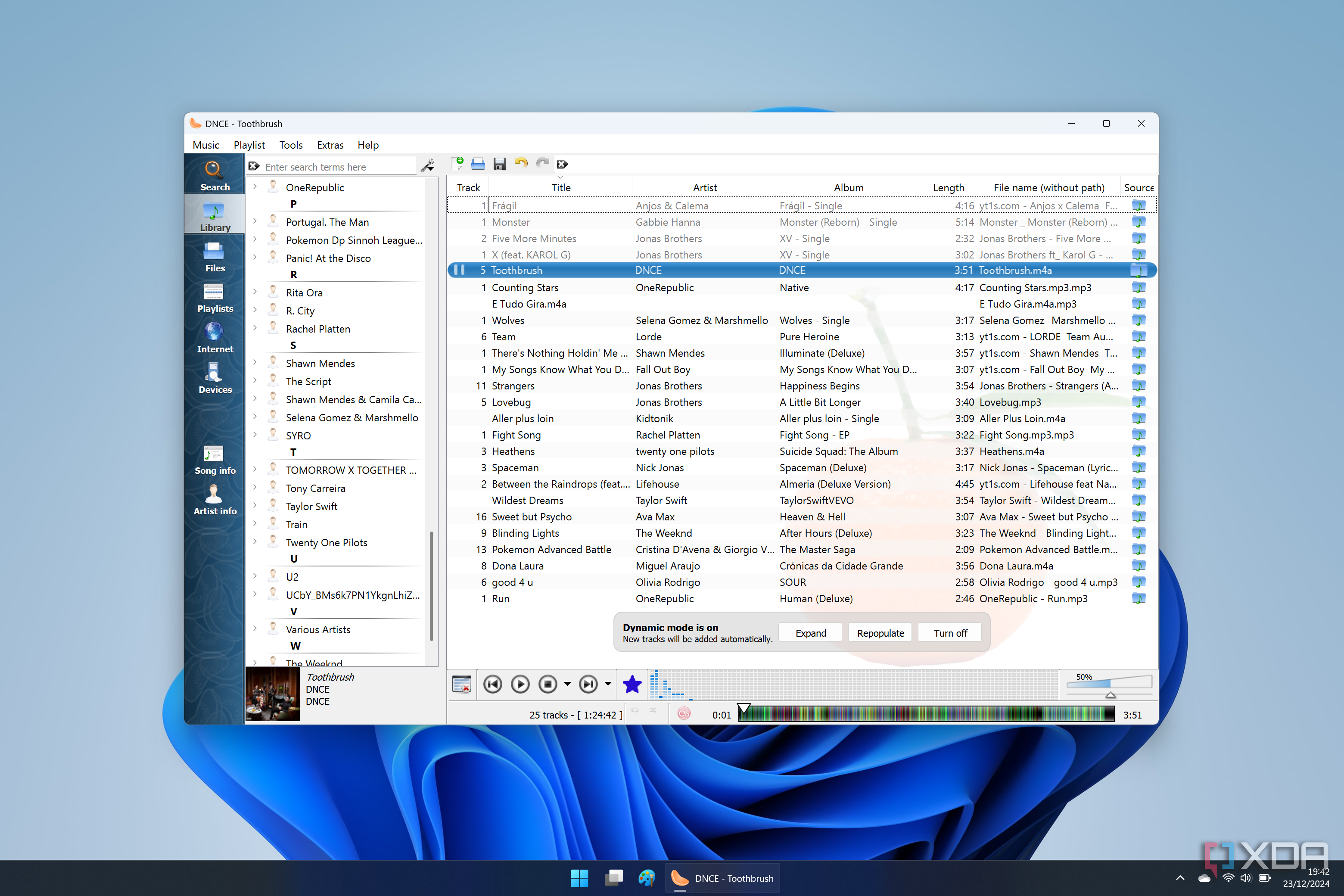 Screenshot of Clementine on Windows 11 with a large playlist loaded and a list of artists on the left side