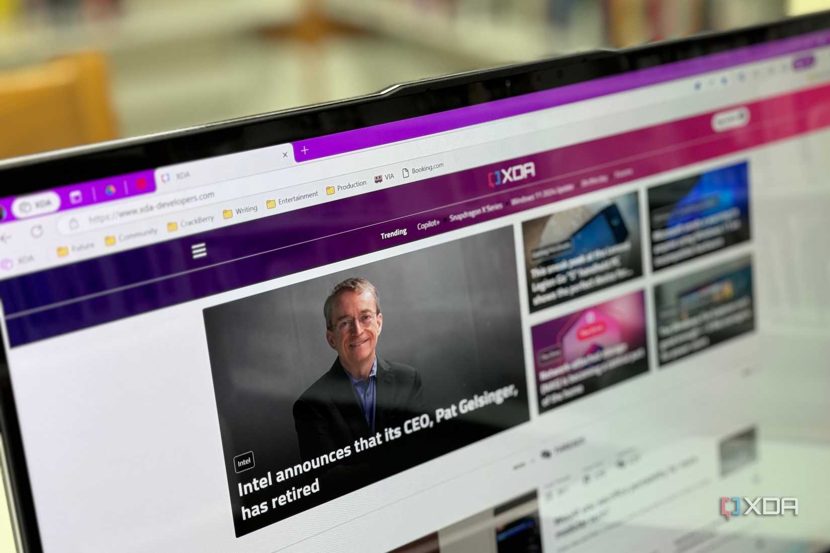 The OLED display on the Acer Swift 16 AI with a bookshelf in the background