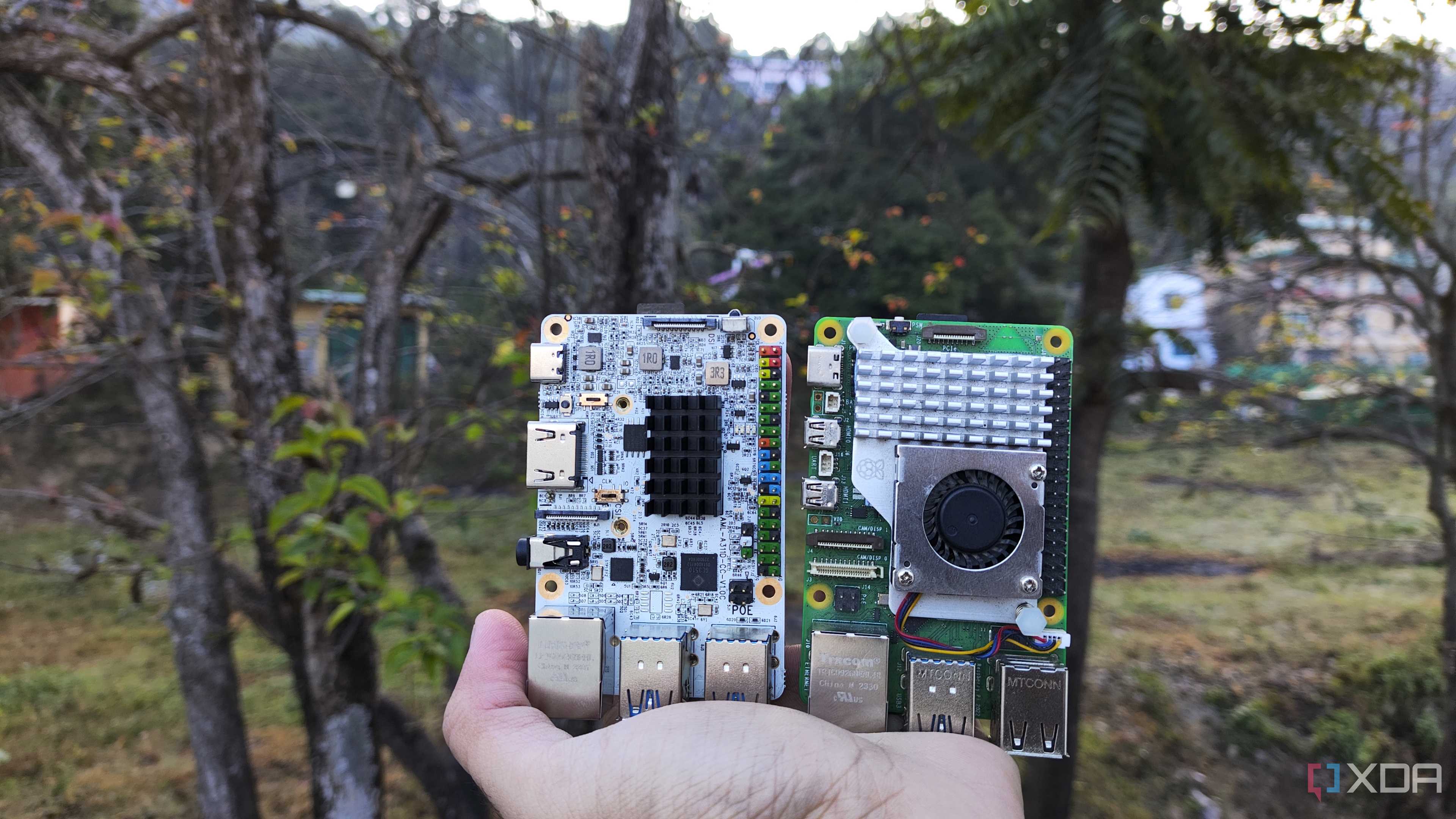 A person holding the Raspberry Pi 5 and Alta SBCs