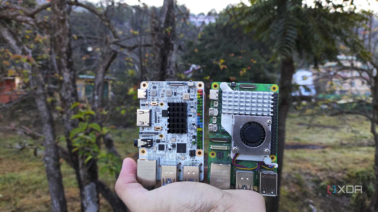 A person holding the Raspberry Pi 5 and Alta SBCs