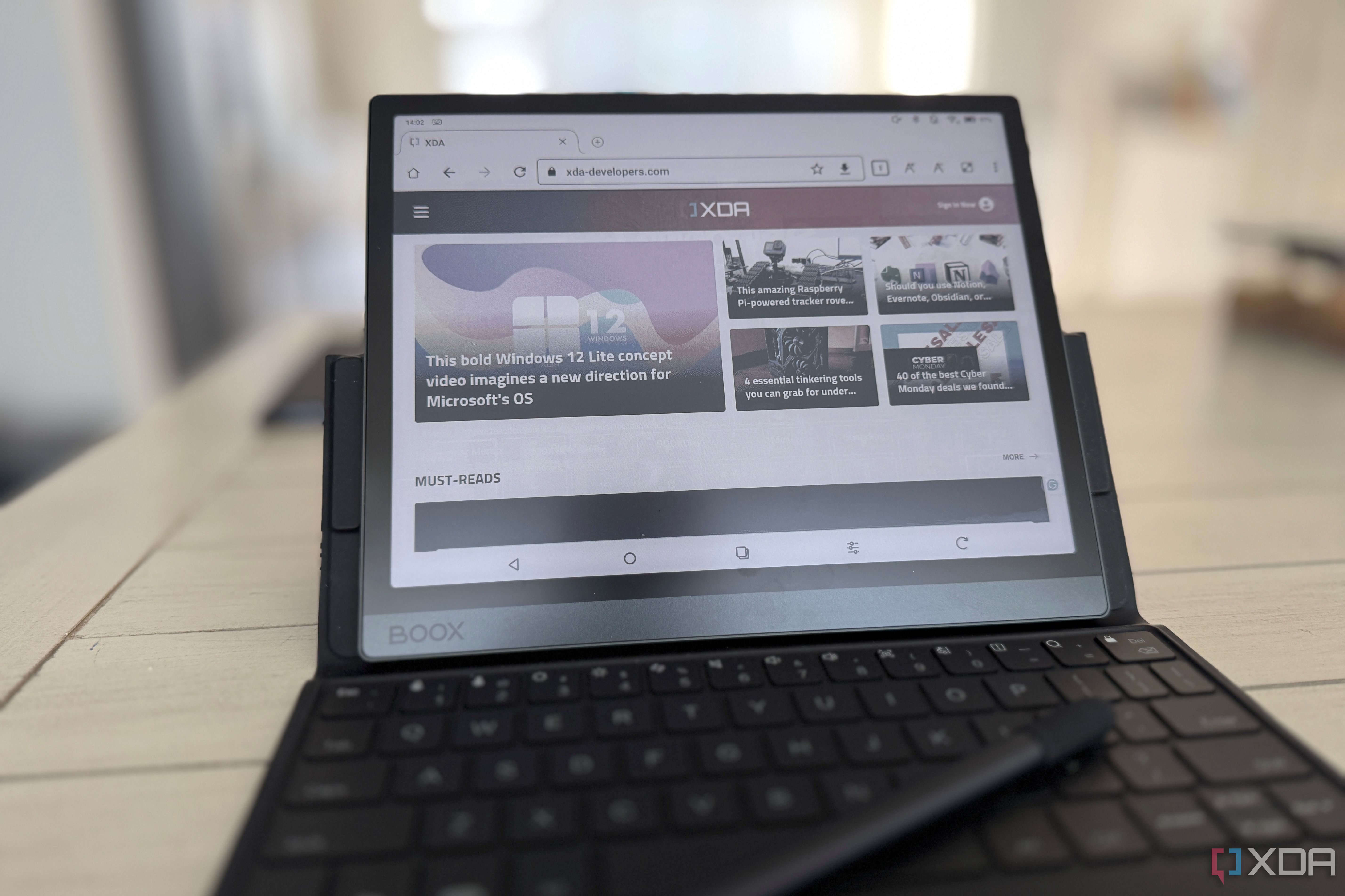 onyx boox tab ultra c pro on a table showing the xda website